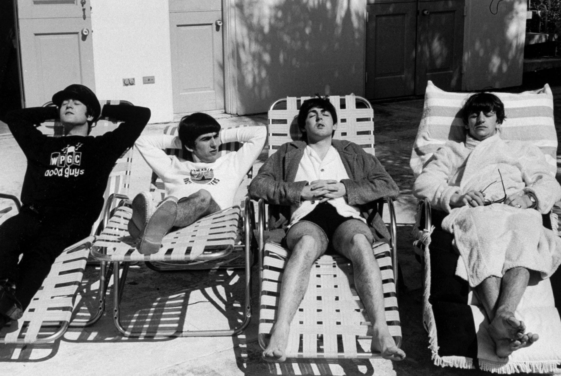 (L-R) John Lennon, George Harrison, Paul McCartney & Ringo Starr, members of British rock group, The Beatles, relaxing on lounge chairs at poolside of the Deauville Hotel. (Photo by Bob Gomel/The LIFE Images Collection/Getty Images)